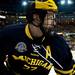 Michigan junior defenseman Mac Bennett on the boards watches a puck in the game against Miami on Saturday, March 23. Daniel Brenner I AnnArbor.com
